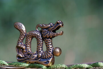 Wall Mural - Dragon figurine with Chinese coins. A religious symbol. Feng shui figurines.