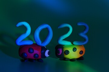 Canvas Print - Two ladybugs and the number 2023 on a blue background. A festive event. New Year and Christmas.