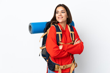 Wall Mural - Young caucasian mountaineer girl with a big backpack isolated on white background laughing