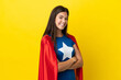 © luismolinero - Super Hero Brazilian woman isolated on yellow background with arms crossed and looking forward