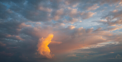 Wall Mural - an epic sunset with colorful clouds lit by the sun. photo of textured sky.