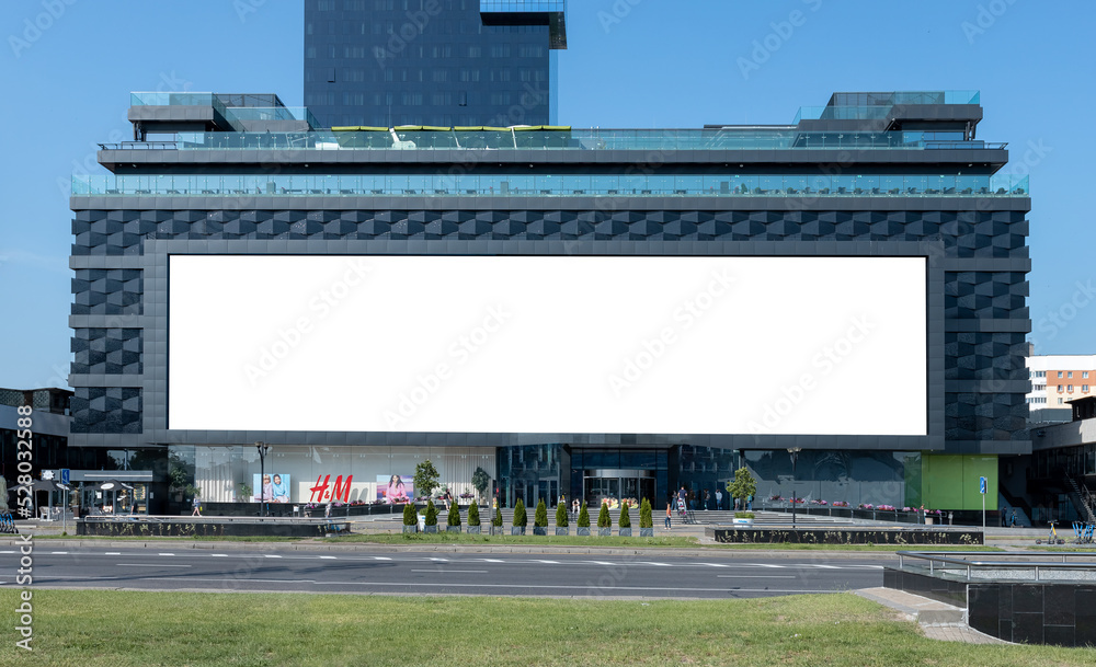 Huge billboard at mall facade in city high traffic area. Business ...