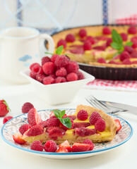 Canvas Print - Round quiche with red strawberries and raspberries on a white table