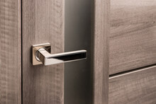 Close Up Of Stylish Silver Chrome Door Handle On Modern Interior Door.