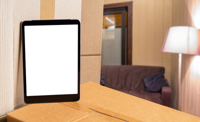 Poster - Relocation offer. Tablet computer on boxes. Tablet with blank white screen. Places for advertising relocation services. Tablet for website. Concept relocation things. Selective focus. 3d image