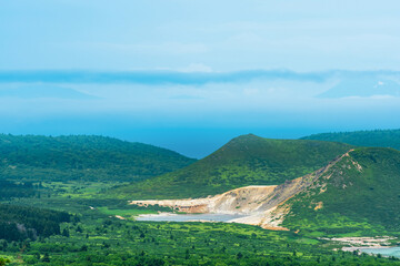 landscape of Kunashir Island, geothermal lakes among lava domes in the center of Golovnin volcano caldera