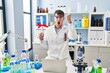 © Krakenimages.com - Young hispanic man working at scientist laboratory holding diploma annoyed and frustrated shouting with anger, yelling crazy with anger and hand raised