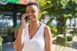 © Krakenimages.com - African american woman smiling confident talking on the smartphone at park