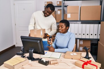 Canvas Print - Man and woman ecommerce business workers scanning package at office