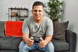 © Krakenimages.com - Young hispanic man angry playing video game at home.