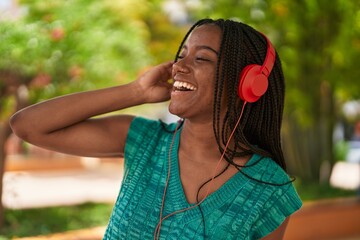 Poster - African american woman smiling confident listening to music at park