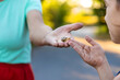 © yanadjan - Grandmother and child are studying the snail in the park. Selective focus.