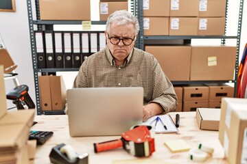 Sticker - Senior caucasian man working at small business ecommerce with laptop skeptic and nervous, frowning upset because of problem. negative person.