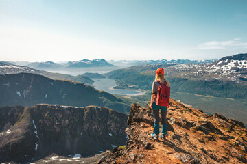 Wall Mural - woman hiking in norway enjoying aerial view on cliff outdoor travel adventure tour active vacations 