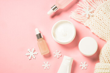 Wall Mural - winter skin care product. winter cosmetic at pink background. flat lay with copy space.