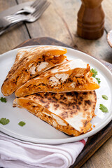 Wall Mural - Pulled chicken and cheddar quesadillas on a plate
