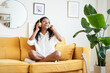 © CarlosBarquero - Beautiful young woman at home enjoys listening music with headphones