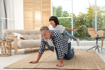 Canvas Print - Happy grandfather with his grandson playing together at home