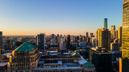 Wall Mural - Chicago, IL USA September 1 2022: establishing aerial drone footage of Chicago downtown during sunset on a mid summer evening. the contemporary buildings are beautiful to watch for tourist  