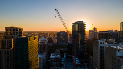 Wall Mural - Chicago, IL USA September 1 2022: establishing aerial drone footage of Chicago downtown during sunset on a mid summer evening. the contemporary buildings are beautiful to watch for tourist  