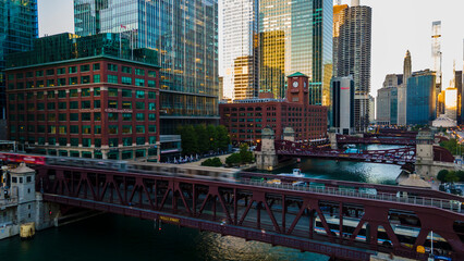 Wall Mural - Chicago, IL USA September 1 2022: establishing aerial drone footage of  the Chicago downtown  train over the lake water during sunset. the city always moving during the course of the day