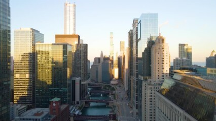 Wall Mural - Chicago, IL USA September 1 2022: establishing aerial drone footage of Chicago downtown during sunset on a mid summer evening. the contemporary buildings are beautiful to watch for tourist  