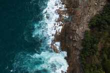 Aerial View Top Down Seashore Big Wave Crashing On Rock Cliff