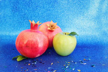 Rosh hashanah (jewish New Year holiday) concept. Taditional symbols over blue glitter background