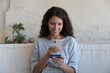 © fizkes - Woman make purchase on-line use debit card and smartphone. Millennial female ordering goods, enjoy remote distancing retail services. E-commerce shopper spend money on internet, secure payment concept