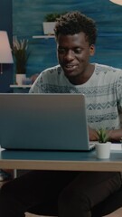 Poster - Vertical video: Business man using video call chatting for business meeting. Person talking on online conference for remote communication at home working on freelance project. Freelancer using laptop
