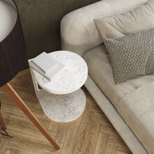 Aerial View Of A Side Table In The Living Room Next To A Sofa With Decorative Cushions. Herringbone Parquet Floor.