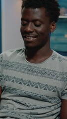 Poster - Vertical video: Black man working from home for business project on laptop. Worker of african american ethnicity using technology for online remote work on modern device. Afro entrepreneur with job