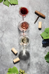 Wall Mural - Wine composition with beautiful sunlight and shadows on grey background. Top view, flat lay