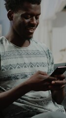Poster - Vertical video: Person using smartphone with touch screen for text messages and remote communication. Man holding gadget and texting, talking to friends as free time activity after online work.