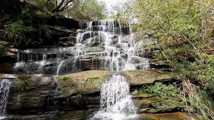 Canvas Print - A multi-tiered waterfall in the forest.