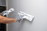 Fototapeta  - Plasterer applies plaster on the wall during repair and restoration work