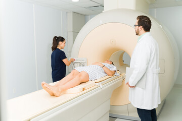 Wall Mural - Technician radiologist starting a resonance medical test at the hospital