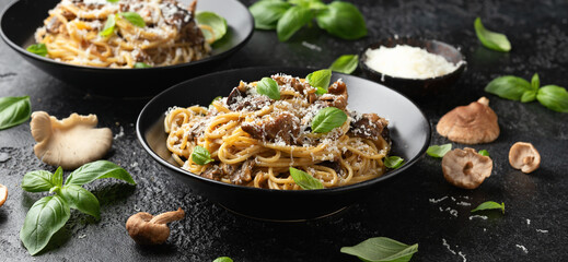 Wall Mural - Porcini and woodland mushrooms pasta with pecorino cheese, basil in black bowl