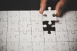 © JD8 - Business woman person hand with puzzle piece idea for strategy and solution. Closeup part of two white jigsaw connect together. Concept of join cooperation success teamwork-problem corporate team.