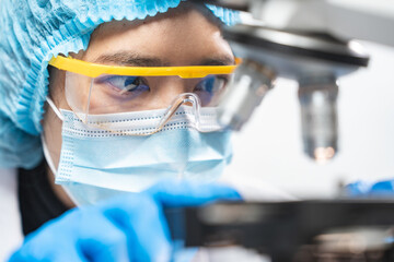 Wall Mural - professional research scientist using microscope in science chemistry laboratory, medical technology
