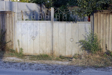 Sticker - one closed rural metal gate on the fence wall in the street