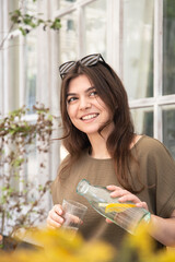 Wall Mural - Attractive young woman drinks water with lemon.