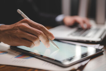 business communication technology concept, businessman person using digital pen to working on tablet computer screen device in modern office workplace, online marketing document on desk table