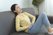 © Pormezz - young woman gripping her stomach have abdominal pain .