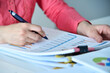 © vetkit - Accountant or businesswoman studying financial report for analysis information.