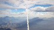 Rocket fly on mountains background