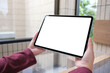 © Farknot Architect - Mockup image of a woman holding digital tablet with blank white desktop screen