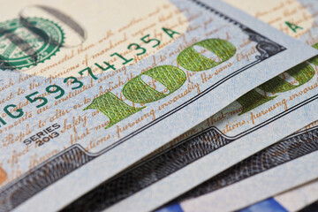 Wall Mural - american banknotes of one hundred dollars. fragment of bills close-up. new sample money. focus on th