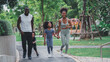 © Me studio - African children and families happily play outdoor sports in the garden.Man jogging with nature in the garden.On summer vacation, the family happily took a walk in nature.