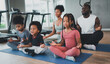 © Me studio - children exercise yoga with family at the gym.The lifestyle of a young body is to take care of one's body.Children wear sports wear to exercise fluently.
